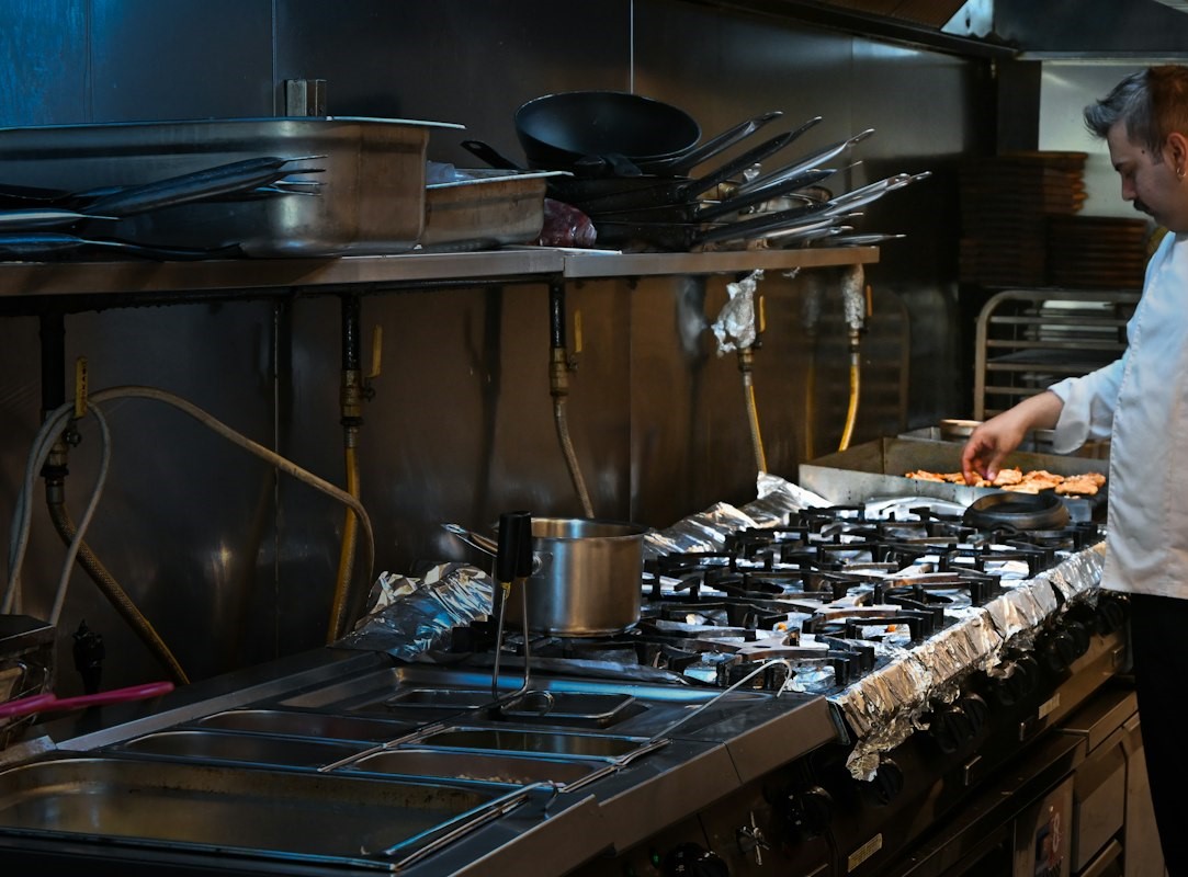 A chef cooking on the line in a commercial kitchen